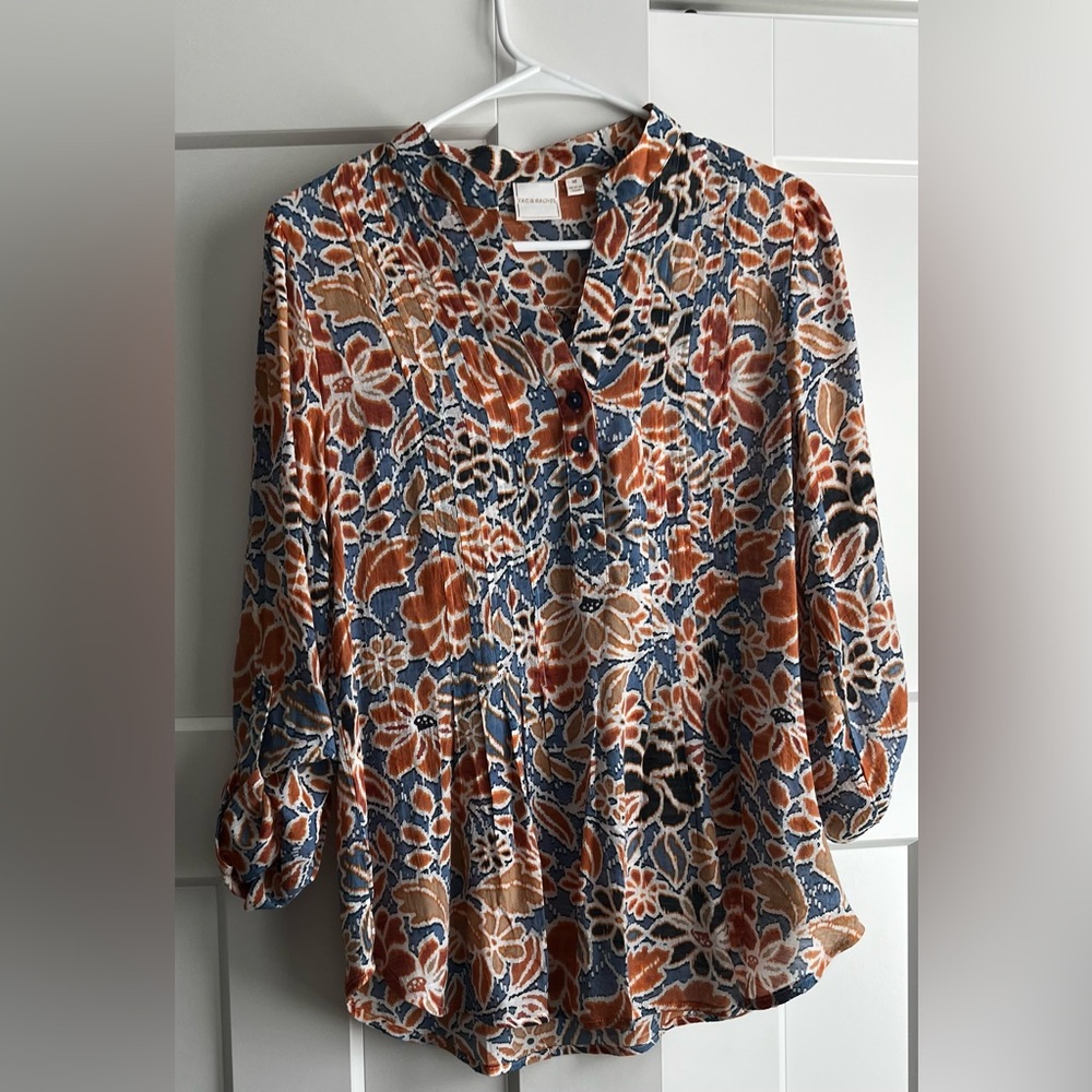 Spring blouse with cuff button sleeves great with light wash denim .